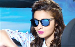 Affable Alia Bhatt in a close up wearing pink lippers & blue shades